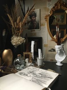 a table topped with vases filled with flowers next to a mirror and other items