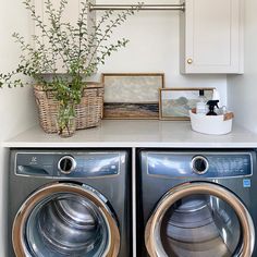 a washer and dryer sitting next to each other in a room with white walls