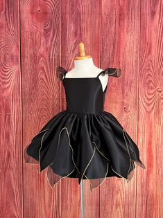 Little Darln Boutique  Black Fairytale Dress  This dress will make the perfect unique Halloween costume or birthday tutu dress for your princess. The blouse is made with black satin material, with spaghetti straps attached with sheer black sleeves, that consist with gold edging, a zipper can be found at the back of the bodice. The skirt is made of sheer/satin & gold edging to give it a fairytale princess silhouette. Underneath the skirt there is two layers of lining with crinoline to give it some fluffiness. Please message me if you are looking for a specific color to match your event.. Visit our store, more items to come!  https://www.etsy.com/shop/LittledarlnBoutique?ref=profile_header Fitted Black Costume For Dress-up, Fitted Princess Dress With Ruffles For Halloween, Black Halloween Costumes For Dress-up, Black Tutu Dress With Ruffles For Dress-up, Black Satin Dress For Costume Party, Fitted Fairy Dress For Halloween Costume, Black Princess Tutu Dress With Ruffles, Black Princess Dress For Dress-up, Black Princess Dress For Party