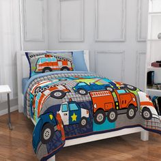 a child's bed with trucks and stars on it