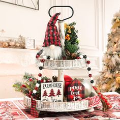 a three tiered tray with christmas decorations