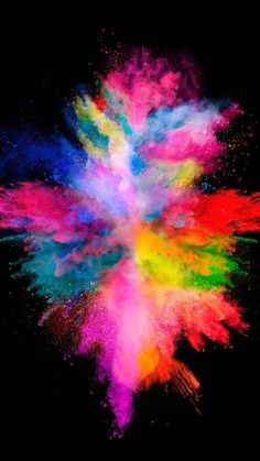 colorful powder exploding in the air on a black background