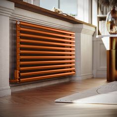 an orange radiator sitting on top of a wooden floor next to a window