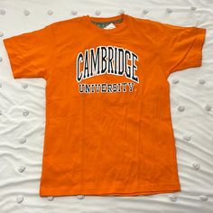 University Of Cambridge Orange T Shirt New Size L Reach Out With Any Question We Always Carefully Package And Box Ship Asap Casual Orange College Tops, Casual Orange Tops For College, Casual Orange T-shirt For College, Orange Short Sleeve T-shirt For College, Orange Graphic Print Top For College, Orange Short Sleeve Tops For College, Mama Bear Hoodie, Army Print, Tommy Hilfiger Top