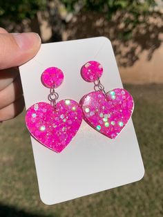 "Each pair of neon sparkly pink heart earrings are handmade to order, therefore no two pairs are identical! Every resin jewelry piece in my shop is slightly unique and one of a kind! However, I try to get as close to the photos as possible :) Made with non-toxic stainless steel stud earrings. Nickel-free & hypoallergenic.  Hearts are approximately 1.25\", and are made with epoxy resin and neon hot pink iridescent glitter ✨  These dangle drop heart earrings are perfect for Valentine's Day, everyd Kawaii Items, Pink Heart Earrings, Resin Accessories, Diy Earrings Polymer Clay, Earrings Handmade Dangle, Kawaii Jewelry, Pink Sparkly, Girly Gifts, Kawaii Accessories