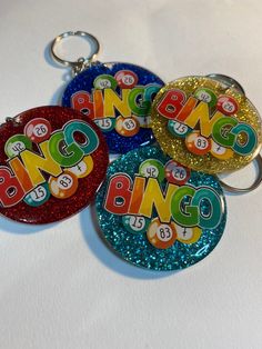 three key chains with the word bingo on them