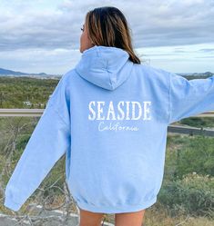 Seaside Beach Hoodies make fun beach vacation gifts perfect for beach lovers.  These pullover hooded sweatshirts have a vintage aesthetic to them and are great beach coverups after getting out of the water or for chilly beach nights. Orders are processed within 24 hours and shipped out within 2 to 5 business days.  What you receive: Gildan brand pullover hoodie with kangaroo pouch pockets Color Choices: White Light Blue Sizes: Unisex adult sizing use size chart as a guide. If you prefer over-siz Cotton Hooded Sweatshirt For Beach Season, Hooded Sweatshirt For Beach Season Vacation, Beach Season Hoodie Sweatshirt, Seaside California, Seaside Sweatshirt, Beach Season Vacation Hooded Sweatshirt, Seaside Oregon, Travel Hoodie, Sweat Vintage