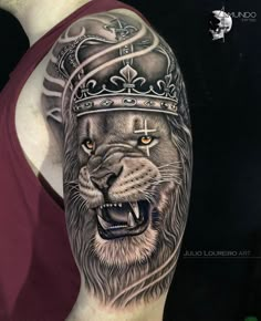 a man's arm with a lion wearing a crown on it and green eyes