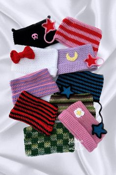 knitted hats and mittens laid out on a bed