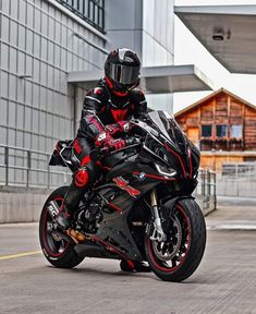 a man riding on the back of a black motorcycle