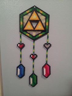 a wall hanging made out of legos on the side of a building with a zelda symbol