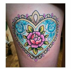 a heart shaped tattoo with flowers on it