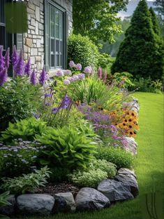 an image of a garden with flowers and plants in the foreground, along side a house