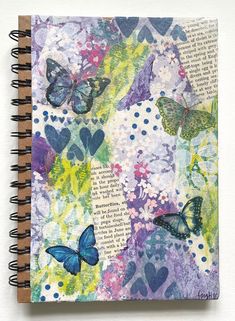 an altered book with butterflies on it