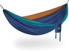 a blue and green hammock hanging from a metal hook on a white background