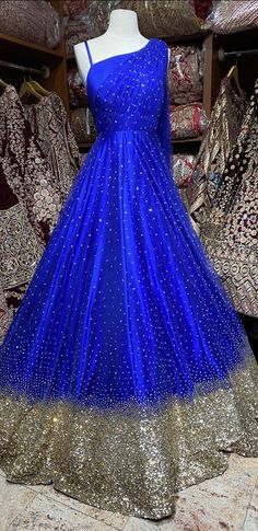 This sparkle blue milky way one-shoulder gown with heavy embellishments with sequin and swaroski work is a contemporary pick with golden sequence border design. Make an grand entry on your special day in this beautiful gown. Fabric: Net Size: 38 Ready to Ship! Blue Embellished Ball Gown For Prom Season, Blue Embellished Ball Gown For Prom, Embellished Blue Ball Gown For Prom, Glamorous Blue Ball Gown For Wedding, Embellished Royal Blue Prom Gown, Blue Sequined Lehenga For Party, Blue Hand Embellished Lehenga For Party, Blue Embellished Gown For Prom Season, Embellished Blue Gown For Prom Season