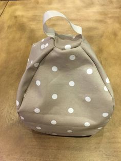 a polka dot purse sitting on top of a wooden table