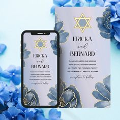 an image of a wedding card with blue flowers on the side and a phone in front