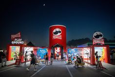 people are standing in front of the entrance to an amusement park at night with panda's play ground