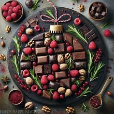 chocolates, raspberries and nuts are arranged in the shape of a christmas ornament