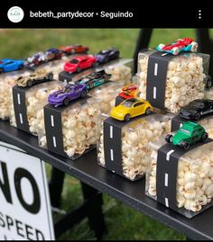 there are many cars on the table with popcorn in front of them and a sign that says no speed limit