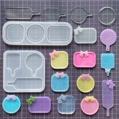 plastic trays with different shapes and sizes on a counter top next to baking utensils