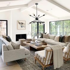 a living room filled with furniture and windows