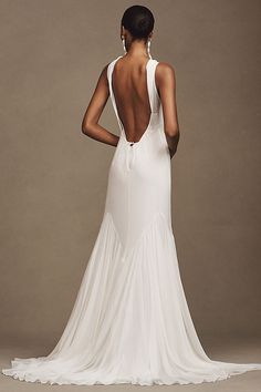 the back of a woman's wedding dress, with an open back and low cut neckline