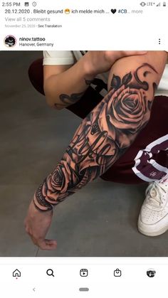 a person sitting on the ground with a tattoo on their arm and leg that has roses all over it