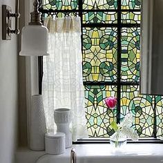 a bathroom with a stained glass window and sink