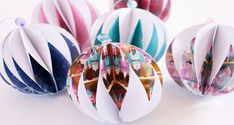 three ornament shaped ornaments on a white surface with different colors and designs in them