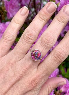 Choose your stone for this stunning dahlia turquoise sterling silver ring! These stones are orange, blue, purple, pink, and copper in color and have been set in sterling silver with a handmade ring band from sterling silver half dome wire. Each stone is 12mm in size. Made to order! Choose your stone and size for a custom ring! Please note that the stock rings are only available in the listed sizes below. Stock Ring 1 sizes 8-8.5. Stock Ring 2 sizes 6-6.5. Stock Ring 3 sizes 7.5-8. These turquois Multicolor Turquoise Round Ring For Anniversary, Multicolor Turquoise Ring For Anniversary, Multicolor Nickel-free Jewelry For Anniversary, Turquoise Round Band Jewelry For Gifts, Multicolor Flower Ring As Gift, Nickel-free Pink Rings For Gifts, Multicolor Flower Ring Gift, Dainty Turquoise Ring Round Shape Gift, Dainty Silver Turquoise Ring Gift