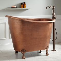 an old fashioned copper bathtub in a bathroom