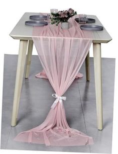 a table with a pink cloth draped over it