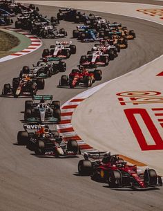 a group of cars driving down a race track