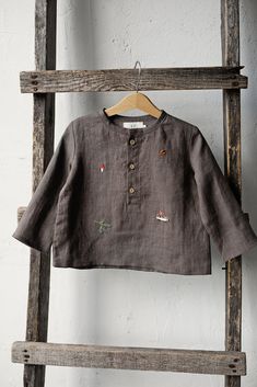 Forest long sleeve unisex shirt with three coconut buttons is made of 100% soft medium weight linen. The shirt is suitable for both girls and boys.  Details: - Choose size in the drop down menu - Colour: Cacao - Composition: 100% Oeko-Tex certified linen - Embroidered hedgehog, pine tree, autumn leaves, mushroom, berries, acorn - from both sides (front and back) - Three coconut buttons in the front - Medium weight linen - Unisex  - Relaxed silhouette - Linen care: machine wash gentle; tumble dry Linen Bag, Style Expert, Tee Dress, Linen Shirt, Unisex Shirt, Kids Dress, Shirts For Girls, Kids Shirts, Autumn Leaves