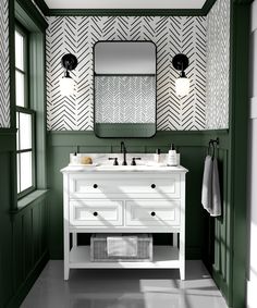 a bathroom with green walls and white furniture in the corner, along with two mirrors