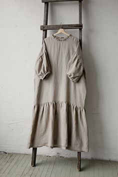 This oversized dress is made from 100% soft and washed linen. Details: - Composition: 100% Oeko-Tex certified linen - Colour: natural - Dropped shoulders - Linen belt - Ruffle skirt and neckline - Size: One size - fits all - Medium weight linen - Linen care: machine wash gentle; tumble dry low, ironing optional - The price is for one dress, other pictured items are not included Measurements: Length (from neck down) - 125 cm (49,2 in) Chest width - 140 cm (55,1 in) Sleeve length (from collar) - 6 Linen Daywear Dress With Ruffles, Linen Ruffle Dress For Daywear, Oversized Beige Lagenlook Dress, Relaxed Fit Linen Ruffle Dress, Oversized Neutral Summer Dress, Relaxed Fit Linen Dress With Ruffles, Relaxed Fit Linen Dress For Brunch, Oversized Short Sleeve Dress For Brunch, Beige Linen Tunic Dress