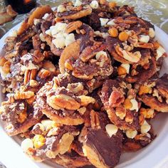 a white plate topped with nuts and raisins