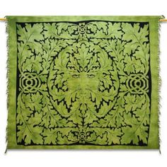 an intricately designed green and black wall hanging