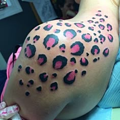 the back of a woman's breast with pink and black leopard print on it