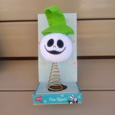 a jack - o'- lantern with a green hat on top of a card