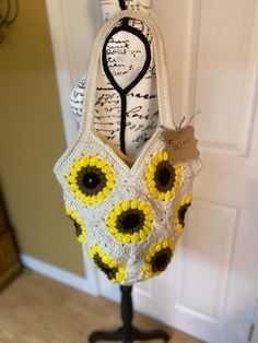 This fun, sunflower crocheted  boho tote is handmade with a creamy base color with bright sunflowers complimented with a bright yellow fabric liner inside Yellow Crochet Tote Bag For Summer, Yellow Crochet Tote Bag For Spring, Yellow Bohemian Crochet Beach Bag, Yellow Crochet Bag For Spring, Spring Yellow Crochet Bag, Yellow Bohemian Tote Beach Bag, Yellow Bohemian Beach Bag Tote, Handmade Cream Crochet Bag For Summer, Yellow Bohemian Crochet Tote Bag