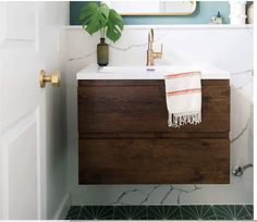 a bathroom sink with a wooden cabinet underneath it