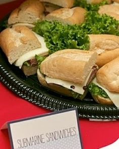 there are sandwiches and salads on the table for people to eat at this party