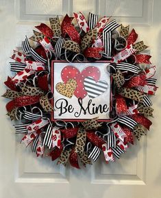 a leopard print and red heart deco mesh wreath with be mine on the front door