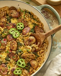 a skillet filled with sausage and rice