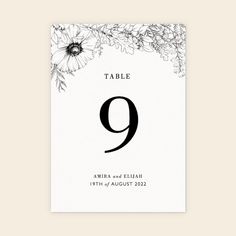 the table number is shown with flowers and leaves in black ink on white card stock photo