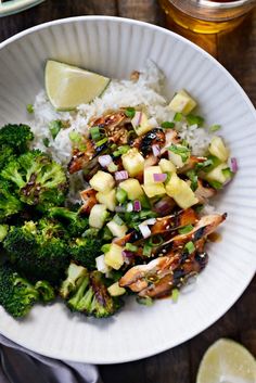 a white plate topped with rice and broccoli