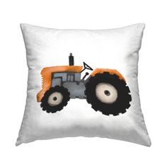 a white pillow with an orange tractor on it